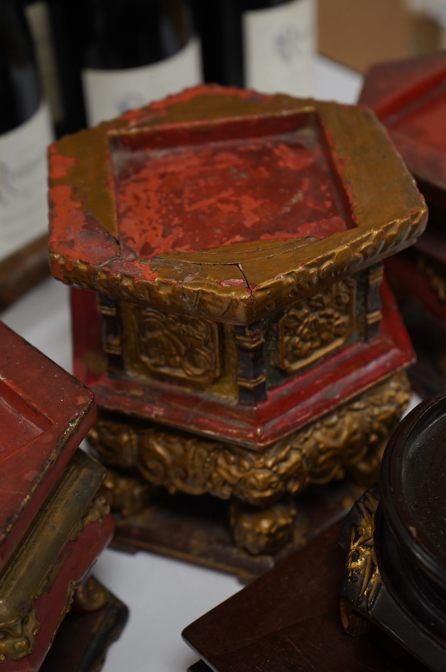 Five Chinese lacquered and partially gilt stands including a hexagonal pair, largest 15cm high. Condition - mostly fair